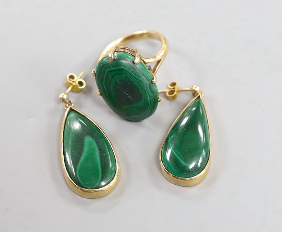 A 9ct gold and malachite set oval ring, size P/Q and a pair of similar earrings, gross weight 20.4 grams.